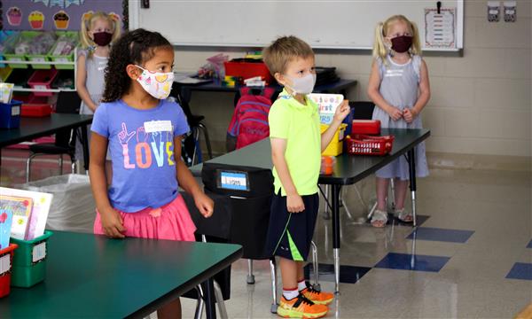 kindergarten students stand in classroom